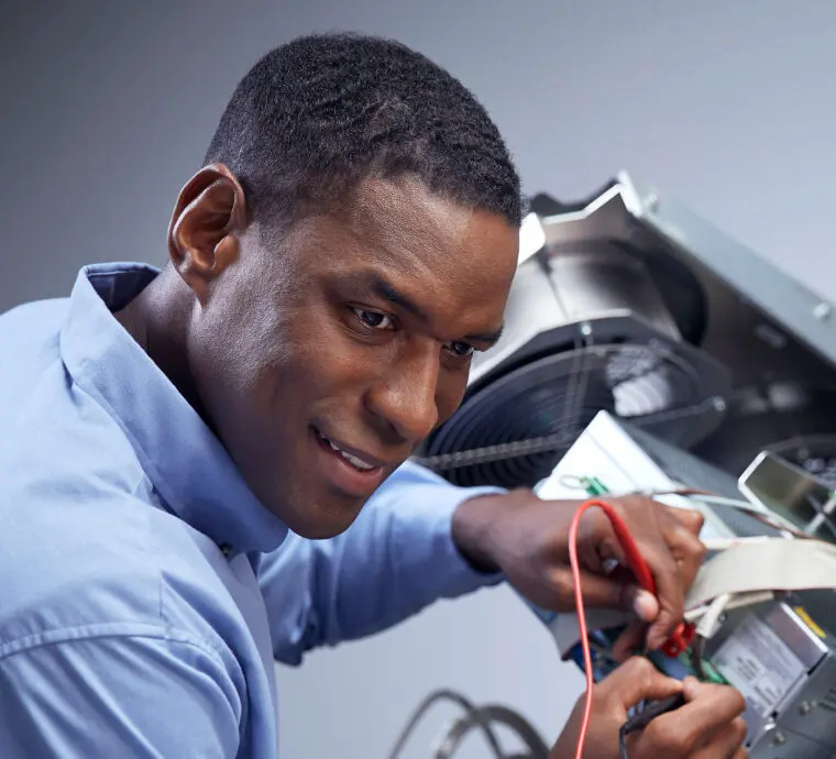 Biomedical technician testing medical equipment with a multimeter