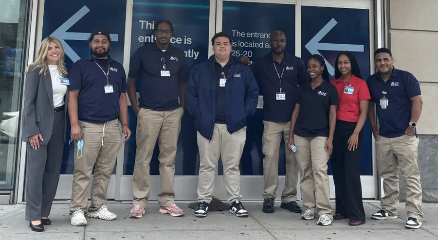 Crothall patient transportation team standing together outside a hospital entrance
